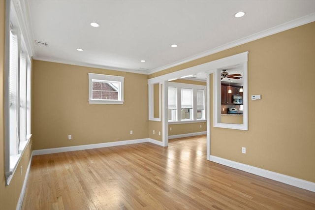 empty room with recessed lighting, light wood-style floors, baseboards, and ornamental molding