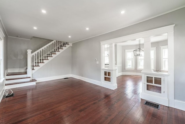unfurnished living room with wood-type flooring, stairway, baseboards, crown molding, and recessed lighting