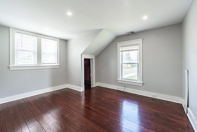 additional living space featuring wood-type flooring, baseboards, and recessed lighting