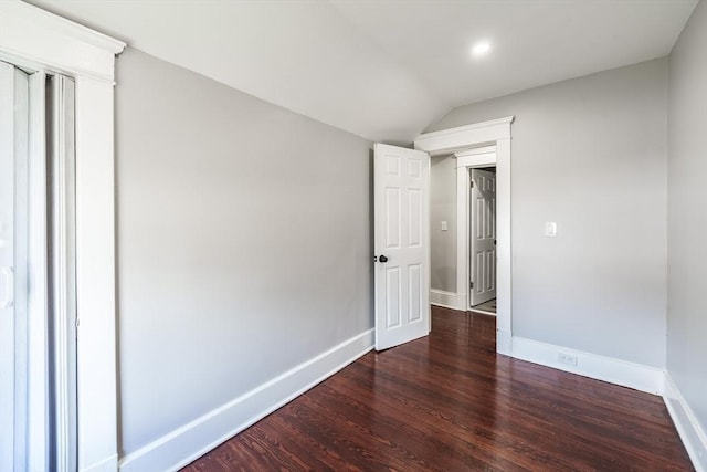 unfurnished room with wood finished floors, baseboards, vaulted ceiling, and recessed lighting