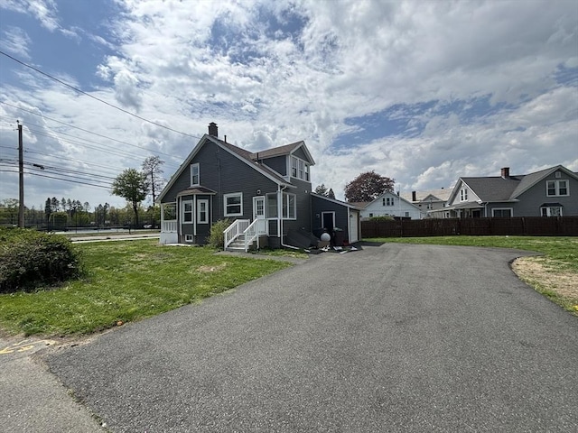 view of home's exterior featuring asphalt driveway