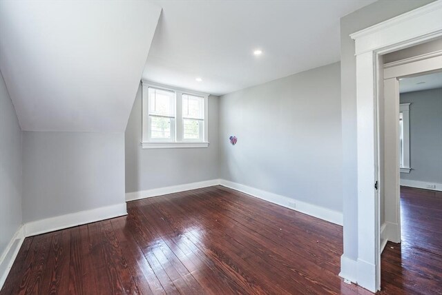 additional living space with hardwood / wood-style floors, baseboards, and recessed lighting