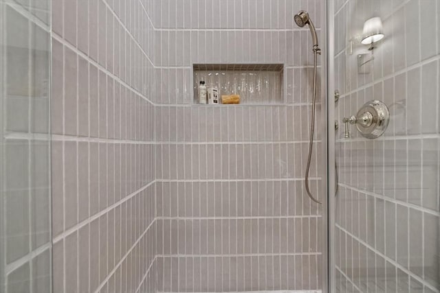 bathroom with a tile shower