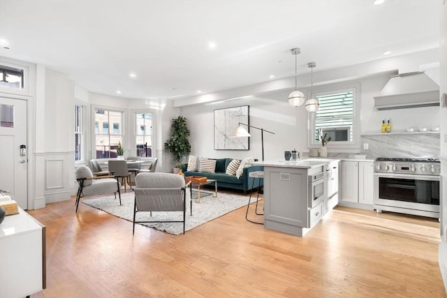 living room with plenty of natural light and light wood-type flooring