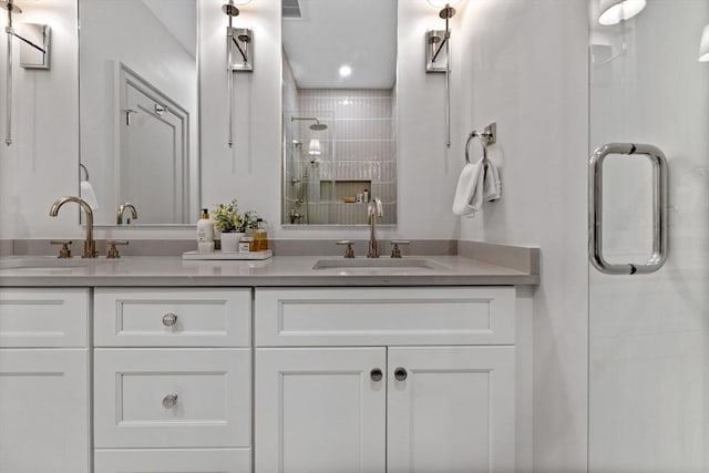 bathroom with a shower with door and vanity