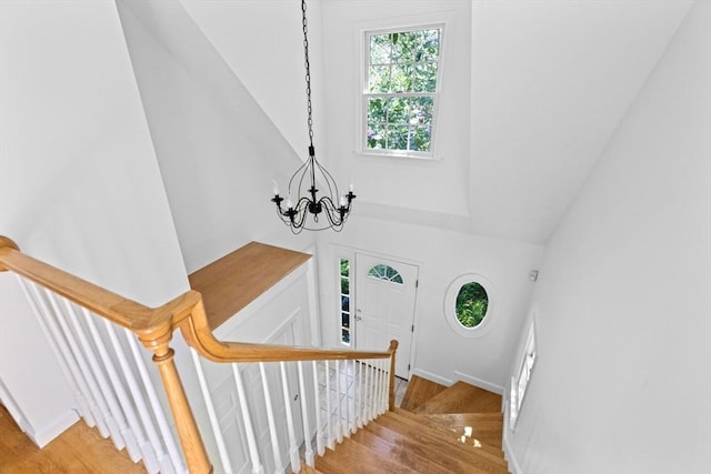 6 Kendall Vlg Unit 6, Cohasset, MA 02025 - stairway with wood finished floors, a chandelier, and high vaulted ceiling