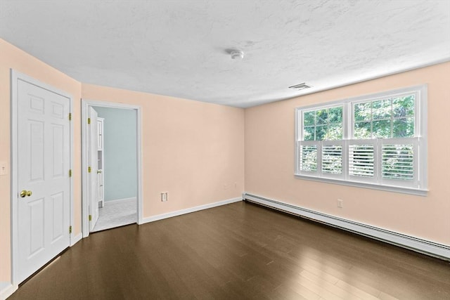 6 Kendall Vlg Unit 6, Cohasset, MA 02025 - unfurnished room with a baseboard heating unit and dark wood-style flooring