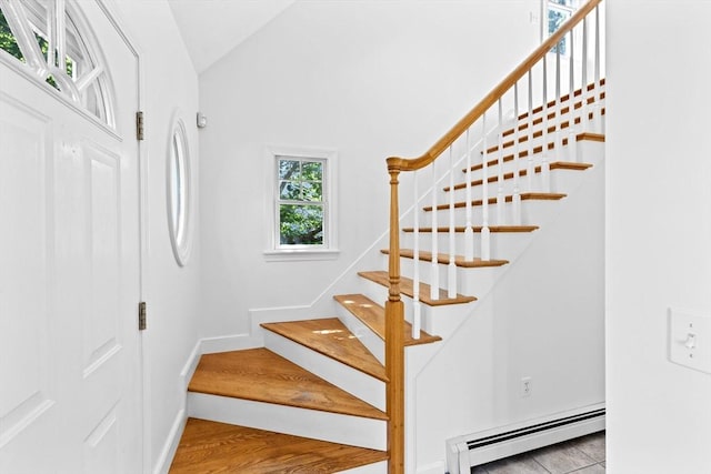6 Kendall Vlg Unit 6, Cohasset, MA 02025 - staircase with a baseboard heating unit, wood finished floors, and vaulted ceiling