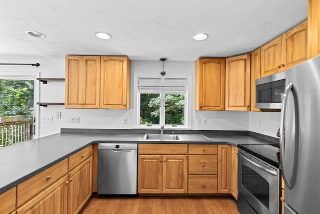 6 Kendall Vlg Unit 6, Cohasset, MA 02025 - kitchen featuring appliances with stainless steel finishes, wood finished floors, recessed lighting, dark countertops, and brown cabinetry