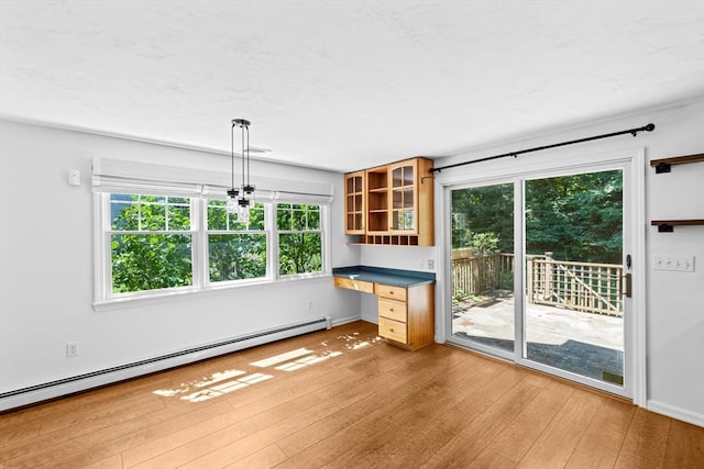 6 Kendall Vlg Unit 6, Cohasset, MA 02025 - unfurnished dining area with a baseboard radiator and light wood-type flooring