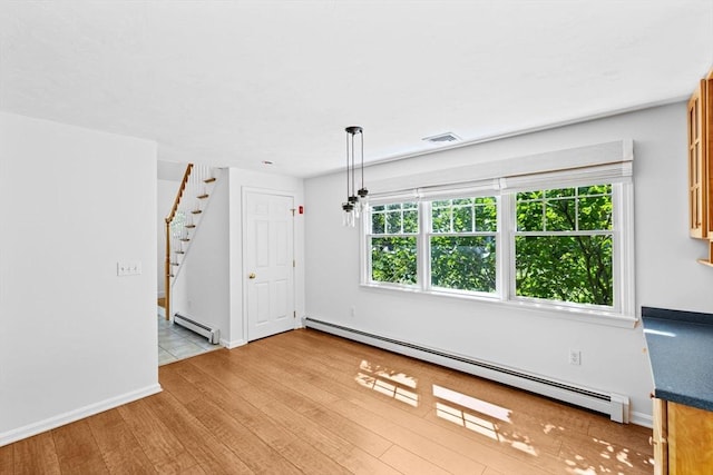 6 Kendall Vlg Unit 6, Cohasset, MA 02025 - unfurnished room with a baseboard heating unit, wood finished floors, and stairs