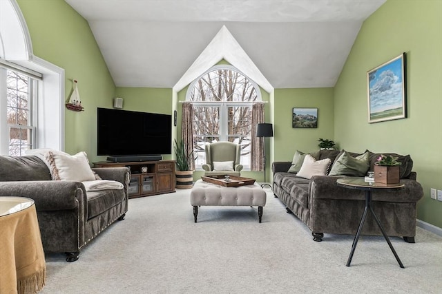 carpeted living room with lofted ceiling