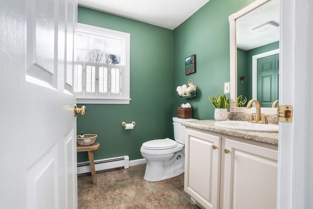 half bathroom with toilet, a baseboard radiator, baseboards, and vanity