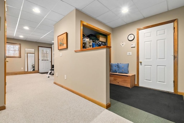 hall featuring carpet floors, a paneled ceiling, baseboards, and recessed lighting