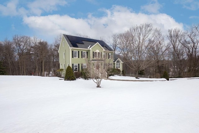 view of front of house featuring roof mounted solar panels