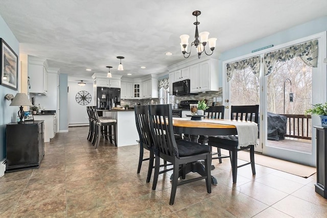 dining space featuring a chandelier, baseboard heating, and recessed lighting