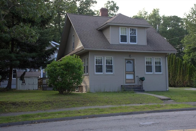 142 College St, Worcester, MA 01610 - view of front facade with entry steps, a chimney, a front yard, and roof with shingles
