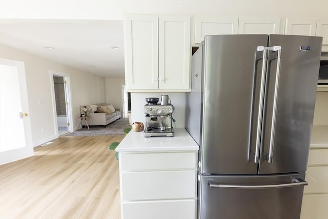 99 Dartmouth St, Westfield, MA 01085 - kitchen with high end refrigerator, white cabinetry, light wood-style flooring, light countertops, and baseboards