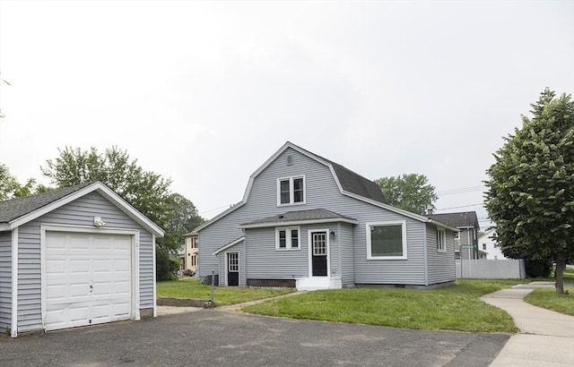 99 Dartmouth St, Westfield, MA 01085 - dutch colonial with an outbuilding, a detached garage, asphalt driveway, a shingled roof, and a front lawn