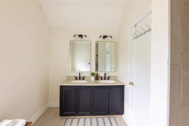 99 Dartmouth St, Westfield, MA 01085 - bathroom with vaulted ceiling, double vanity, and baseboards