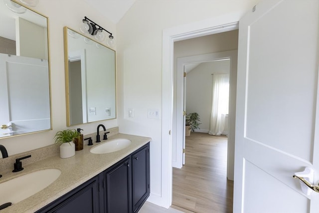 99 Dartmouth St, Westfield, MA 01085 - full bath featuring double vanity, wood finished floors, and vaulted ceiling