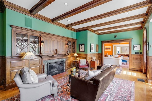 26 Winter St, Salem, MA 01970 - living area with wainscoting, beam ceiling, light wood finished floors, a premium fireplace, and ornamental molding