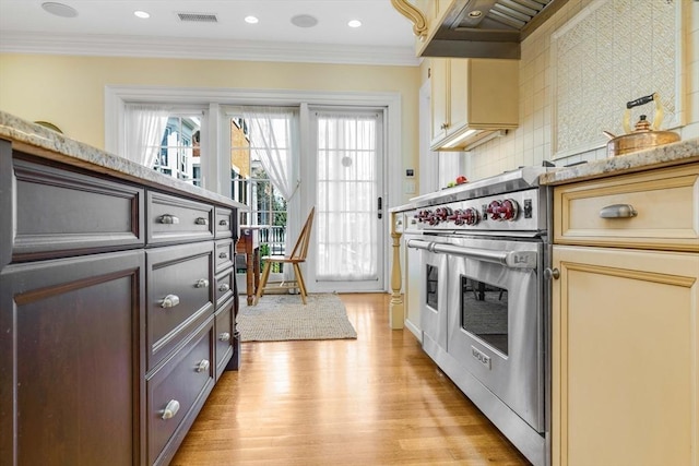 26 Winter St, Salem, MA 01970 - kitchen with light wood-type flooring, double oven range, tasteful backsplash, crown molding, and light stone counters