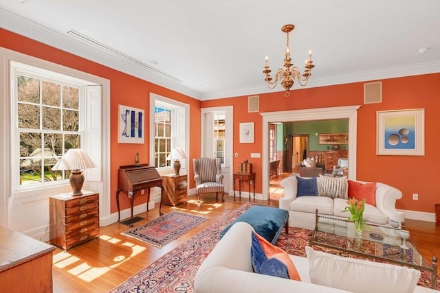 26 Winter St, Salem, MA 01970 - living room featuring a chandelier, light wood-style floors, plenty of natural light, baseboards, and crown molding