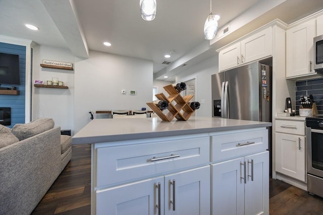 12 Fairmount Ave, Brockton, MA 02301 - kitchen featuring appliances with stainless steel finishes, dark wood finished floors, white cabinets, recessed lighting, and tasteful backsplash