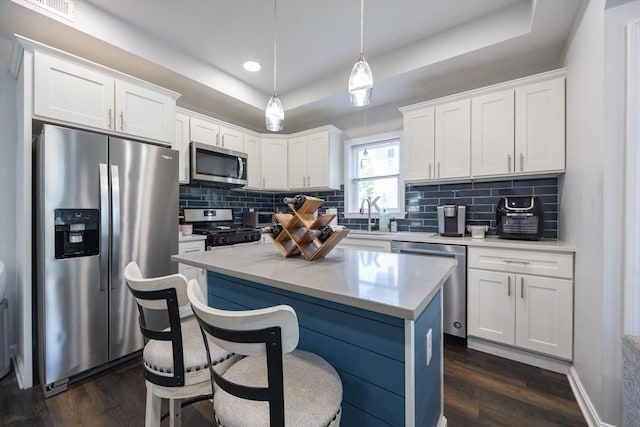 12 Fairmount Ave, Brockton, MA 02301 - kitchen with stainless steel appliances, a raised ceiling, dark wood finished floors, decorative backsplash, and recessed lighting