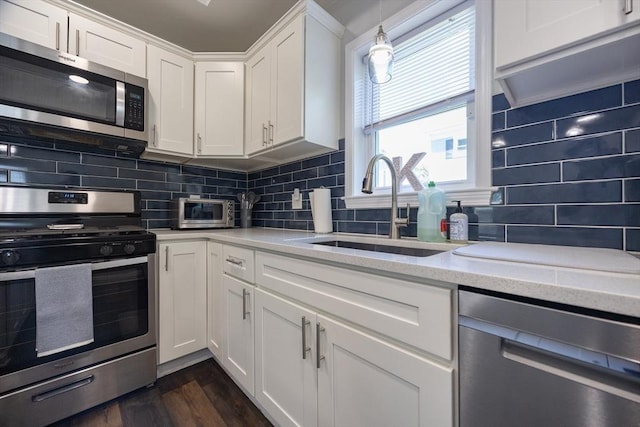 12 Fairmount Ave, Brockton, MA 02301 - kitchen with stainless steel appliances, white cabinets, backsplash, dark wood finished floors, and light stone countertops