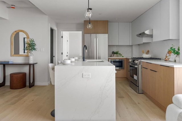 125 Lowell St Unit 3A, Somerville, MA 02143 - kitchen featuring under cabinet range hood, stainless steel gas range oven, modern cabinets, and fridge