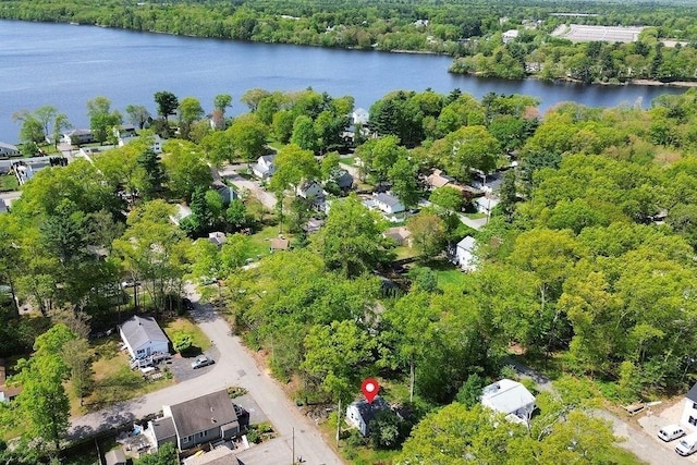 aerial view of property and surrounding area with a large body of water and a forest