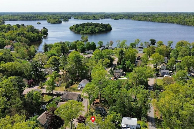 aerial view of a nearby body of water and a heavily wooded area