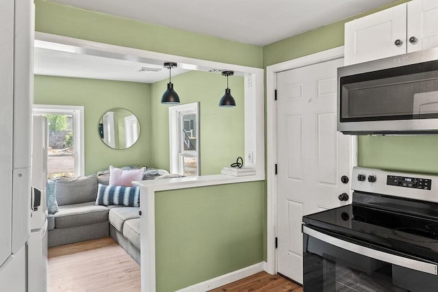 washroom featuring wood finished floors and baseboards