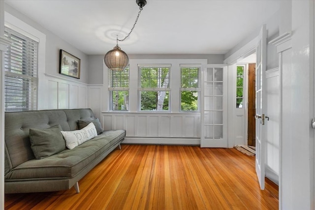 117 Parker Rd, Barnstable, MA 02655 - sitting room with a baseboard heating unit, healthy amount of natural light, light wood-style flooring, a wainscoted wall, and a decorative wall