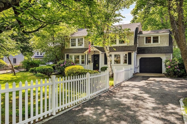 117 Parker Rd, Barnstable, MA 02655 - shingle-style home featuring driveway, a garage, a fenced front yard, and a shingled roof