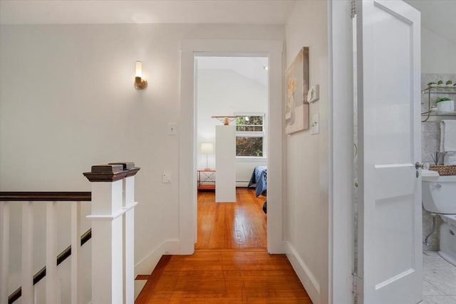 117 Parker Rd, Barnstable, MA 02655 - corridor featuring light wood-style flooring, a baseboard heating unit, baseboards, and lofted ceiling