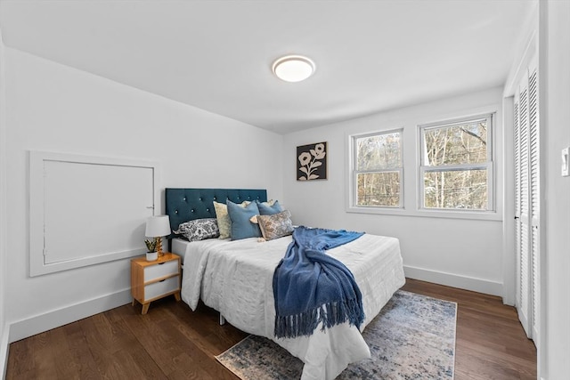 bedroom with dark hardwood / wood-style floors