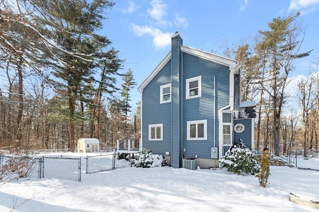 view of snowy exterior with cooling unit