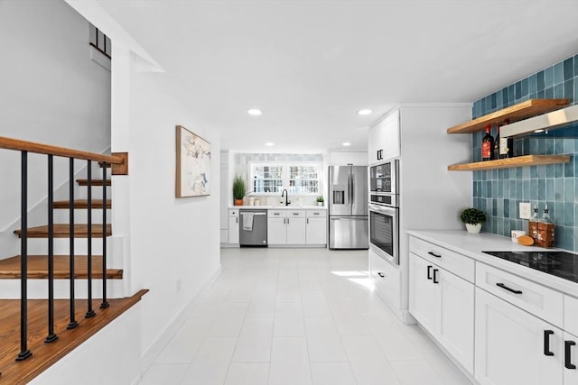 kitchen featuring appliances with stainless steel finishes, sink, and white cabinets