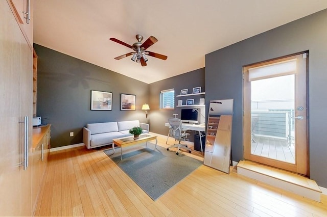 living room with vaulted ceiling, ceiling fan, wood finished floors, and baseboards