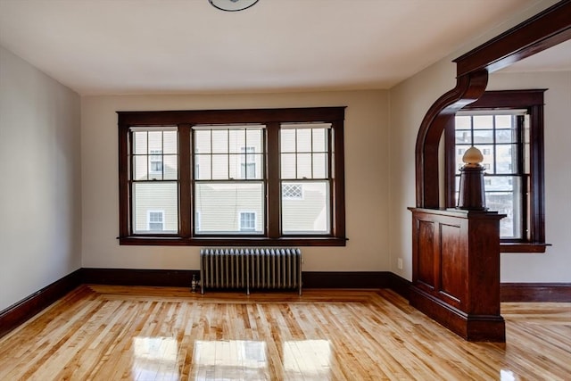 174 Vernon St, Worcester, MA 01610 - empty room with radiator heating unit, light wood-style floors, and baseboards