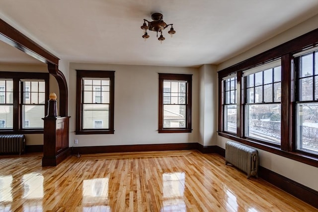 174 Vernon St, Worcester, MA 01610 - unfurnished room featuring radiator heating unit, healthy amount of natural light, and light wood-type flooring