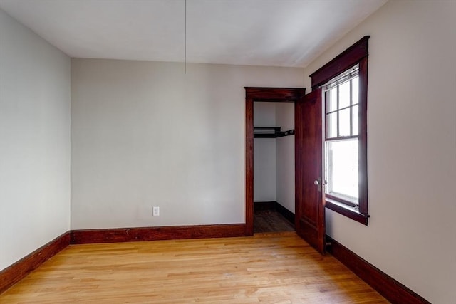 174 Vernon St, Worcester, MA 01610 - unfurnished bedroom with multiple windows, baseboards, and light wood-type flooring