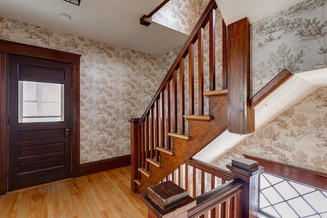 174 Vernon St, Worcester, MA 01610 - foyer with wood-type flooring, wallpapered walls, stairway, and baseboards