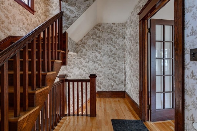 174 Vernon St, Worcester, MA 01610 - stairway with wallpapered walls, wood-type flooring, and vaulted ceiling
