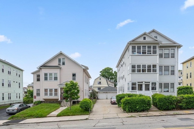 174 Vernon St, Worcester, MA 01610 - view of front of property with an outdoor structure, a detached garage, and a front yard
