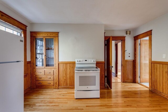 174 Vernon St, Worcester, MA 01610 - kitchen with white appliances, wainscoting, light wood-style flooring, and wooden walls