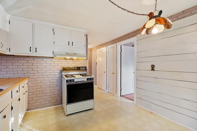 kitchen with white range oven, white cabinets, and extractor fan